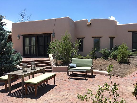 Beautiful double french doors leading to a generous patio ar