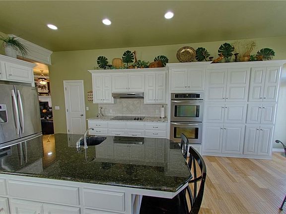 Island with prep sink view, double ovens, and storage,  Not to mention those splendidly light, showstopper floors.