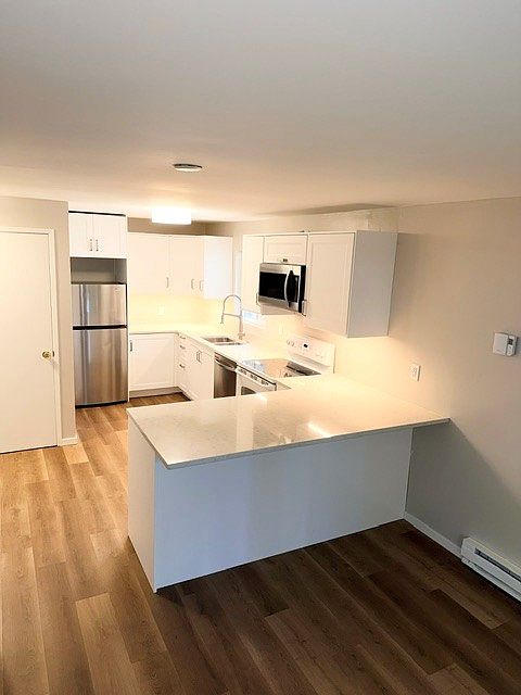 Fully remodeled kitchen with new cabinets, flooring, countertops and dishwasher.
