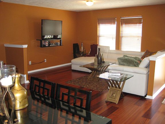 Large living space with partitions and wood blinds.  Lots of natural light.