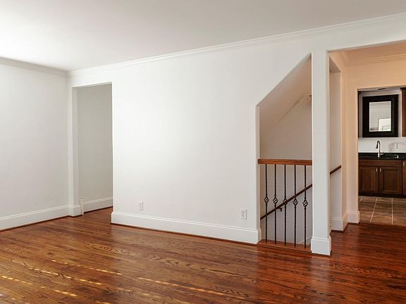 Main floor living area, staircase to finished basement.