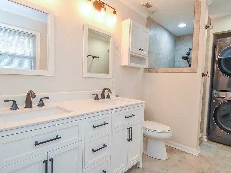 Primary bathroom with washer and dryer