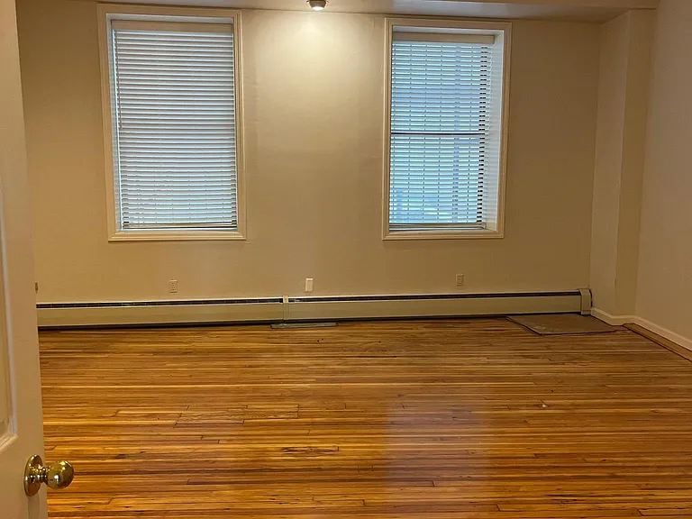 Extra Large Bedroom with refinished wood floors.