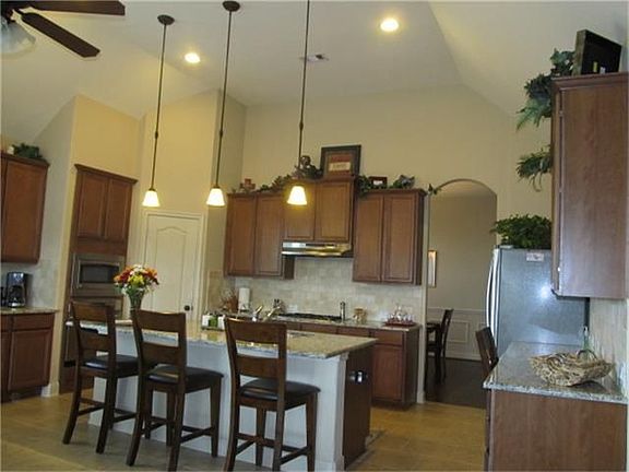  Kitchen made for entertaining, oversized granite counter island, stainless appliances, 42"  solid wood cabinets, breakfast area