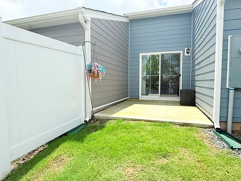 Back patio area with privacy fence