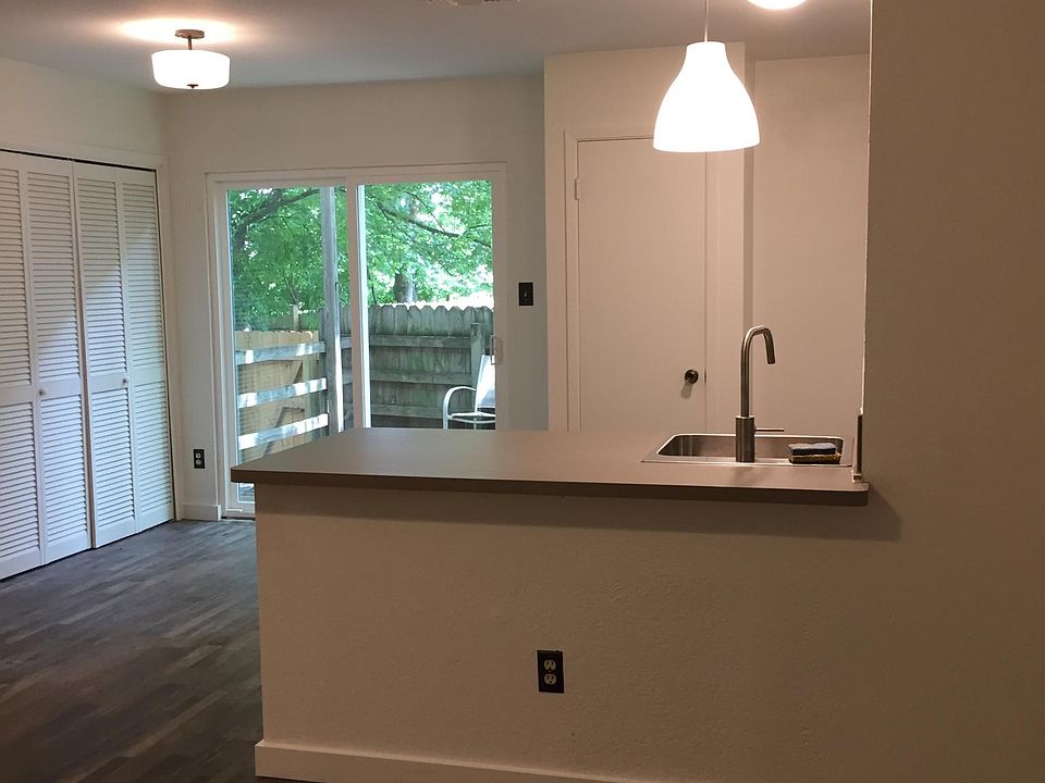 View from the living room through the kitchen, to the sliding glass door leading onto your deck. The louvered doors on the left side of the picture are to the laundry closet.