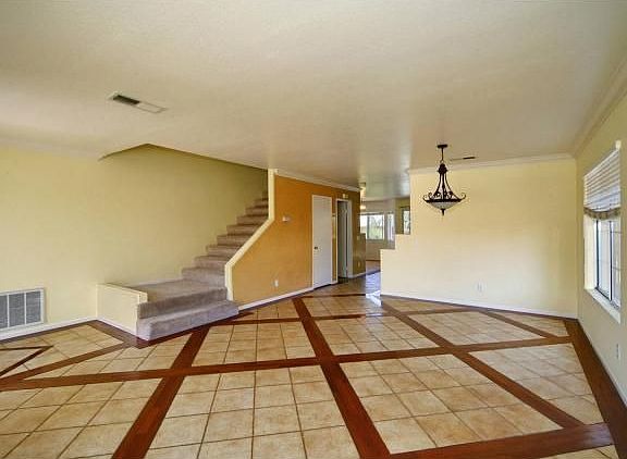 View through living room into dining area and upstairs.