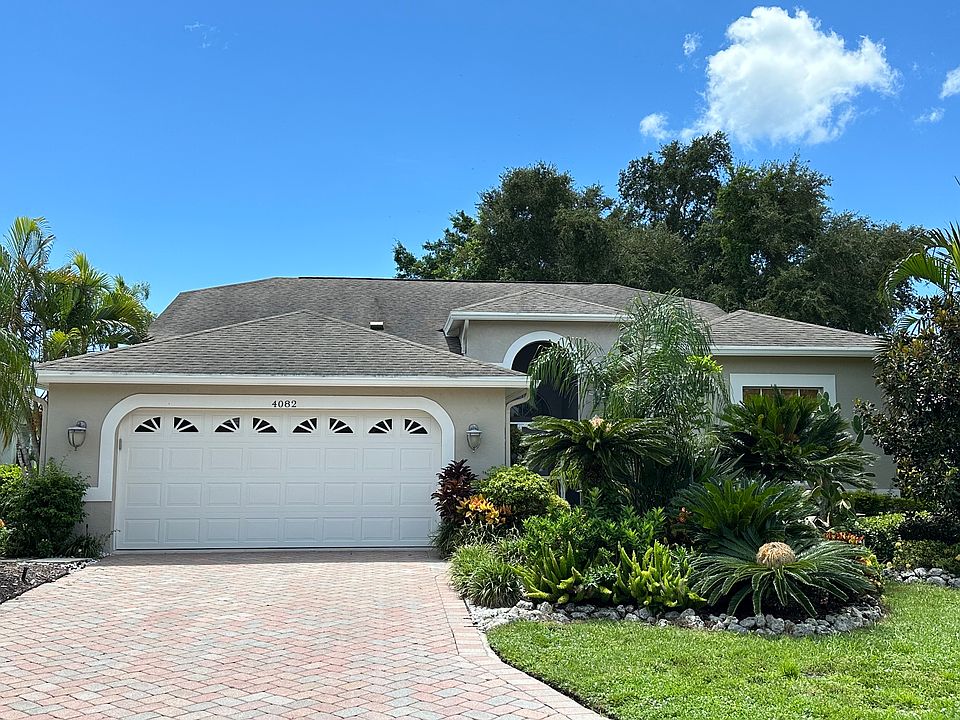 Newly painted exterior of home with gorgeous landscaping and local foliage.