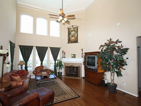 Den with wood floors, fireplace, open to the kitchen and breakfast with pool v