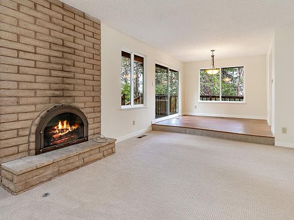 Views from almost every room. Dining area and step down living room with fireplace and skylight.