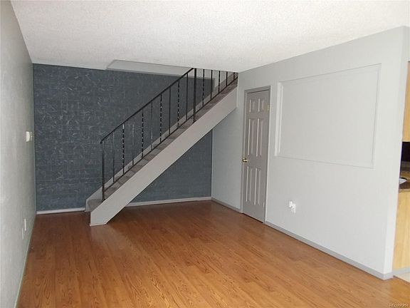 View of your Living Room as you step inside!  Light gray walls with dark and medium gray accent walls and trim.