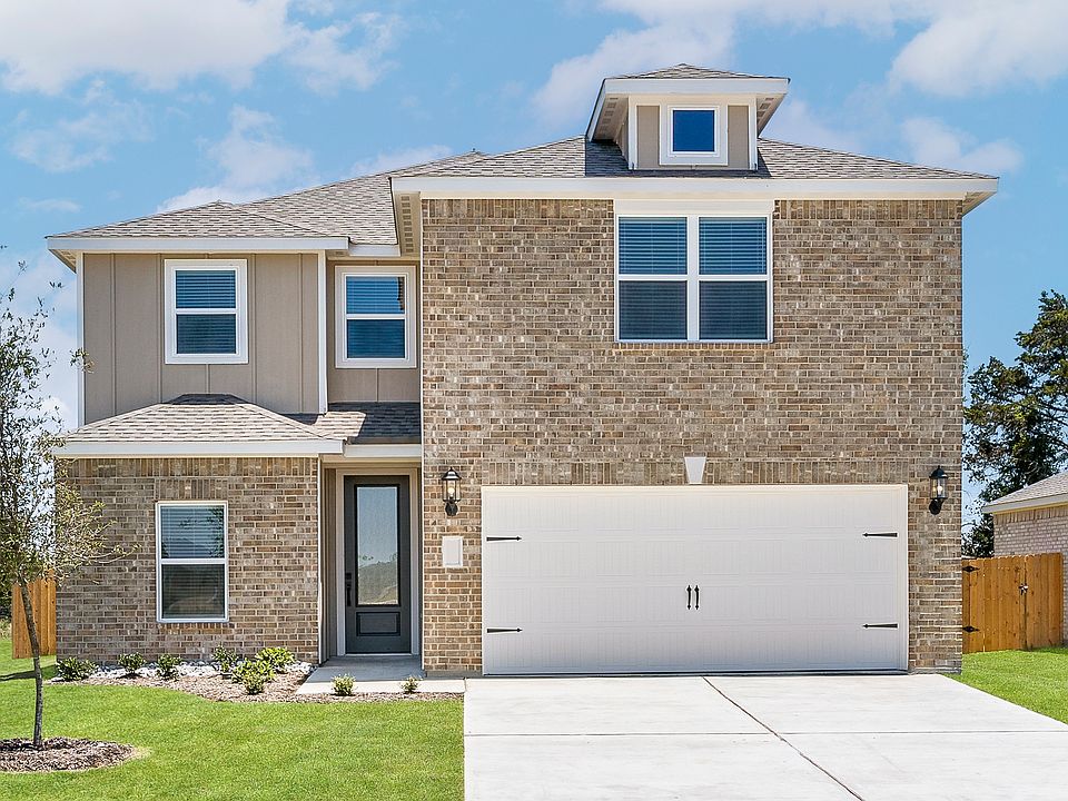 The two-story Driftwood plan has a gorgeous brick exterior with siding detail.