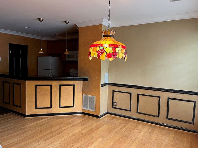 Dining room with kitchen in background.