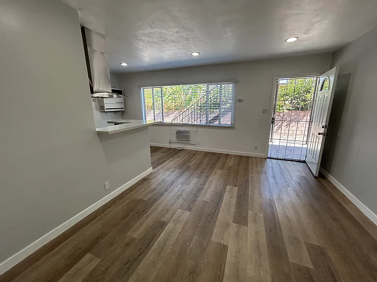 Living room facing natural light from window and front door.