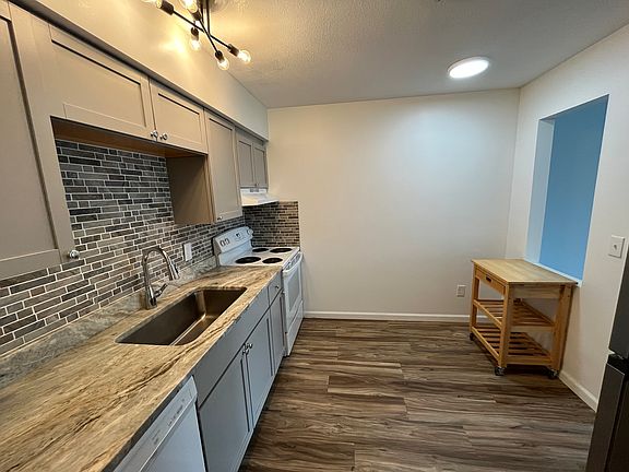 Updated kitchen with tile backsplash and granite countertops.