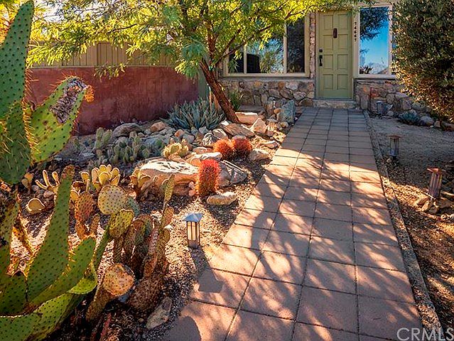 Colorful cactus & succulents guide your footsteps to the front door