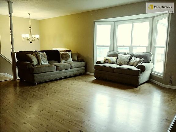LIVING RM WITH BOOKCASES AND FIREPLACE
