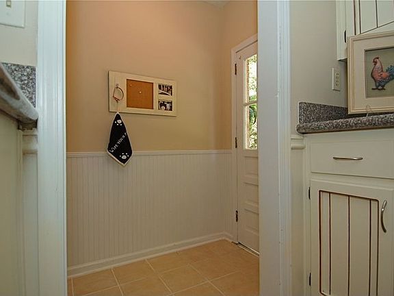 Mud room w/beadboard paneling & tile floor greets you as you enter from garage