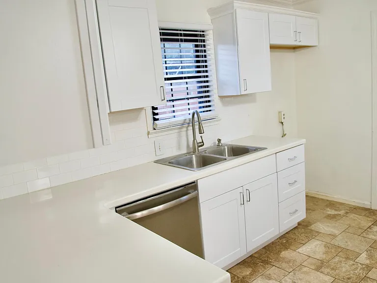 Kitchen view 1 - updated cabinets and sink new dish washer and refrigerator .