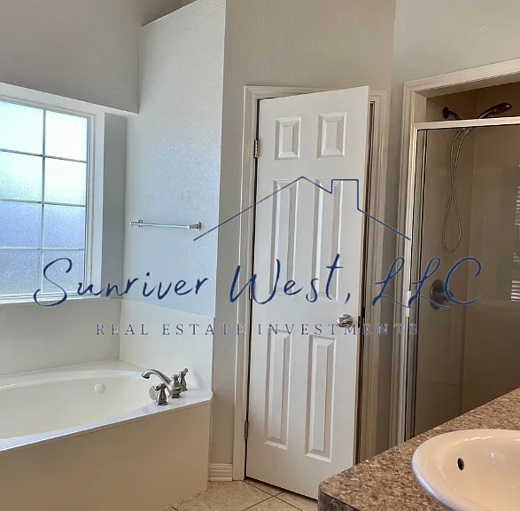 Primary bath with large tub, separate shower & 2 closets