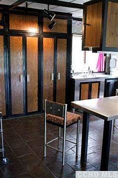 Kitchen detail with slate floors, aluminum fixtures and stools. All custom built and included with the house
