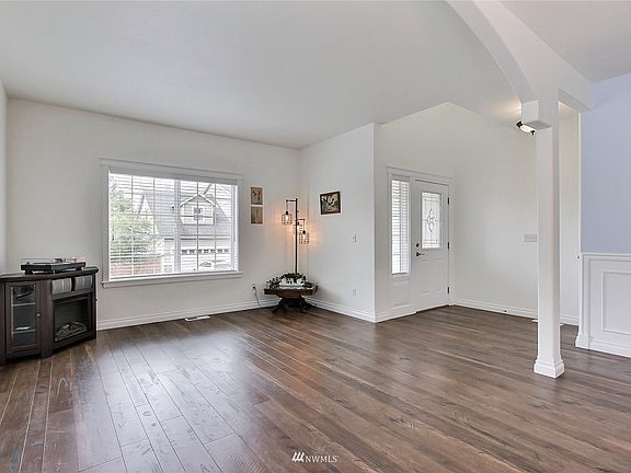 As you enter, you will find great hardwoods throughout this first level, open-concept formal living room to dining with arch and pillar for great character. >