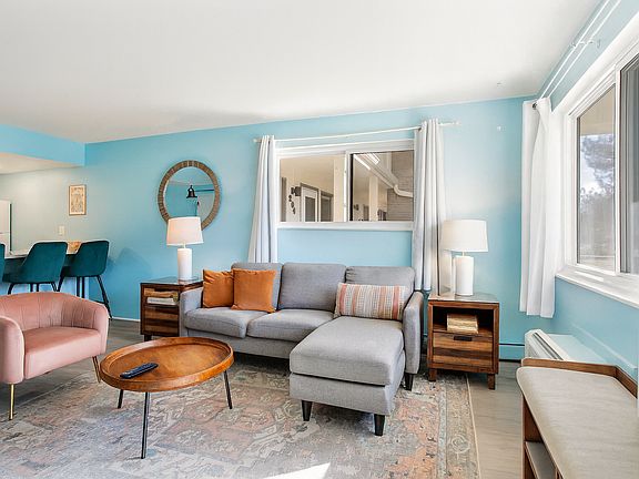 Sink into the soft sectional, bask in the natural light, and enjoy the cheerful, welcoming energy that makes this space feel like a true getaway.