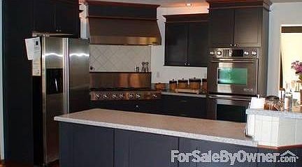 Kitchen
						:
						Custom Kraft Maid Kitchen with Jenn Air appliances and corian countertops
