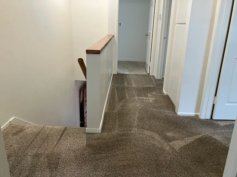 Hallway to two bedrooms, linen closet, and laundryroom.