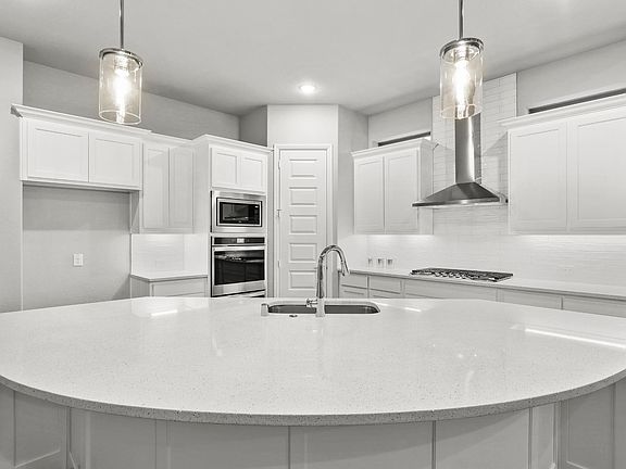 REPRESENTATIVE PHOTO - Kitchen in the Waldorf home plan by Trophy Signature Homes