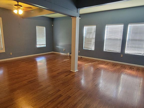 Living and dining room. Very open with ceiling fans and laminate wood floor