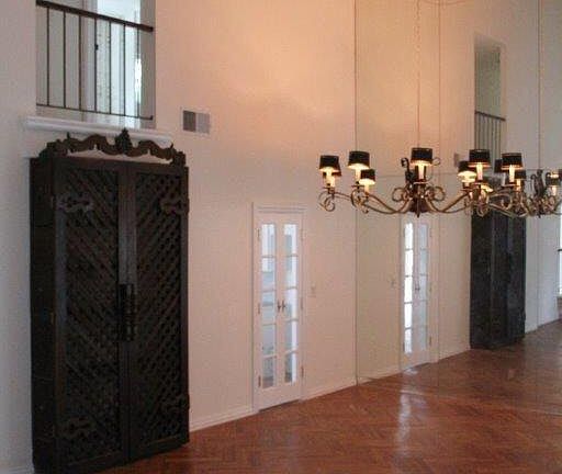 Living room with mirrored wall and 30 foot vaulted ceilings