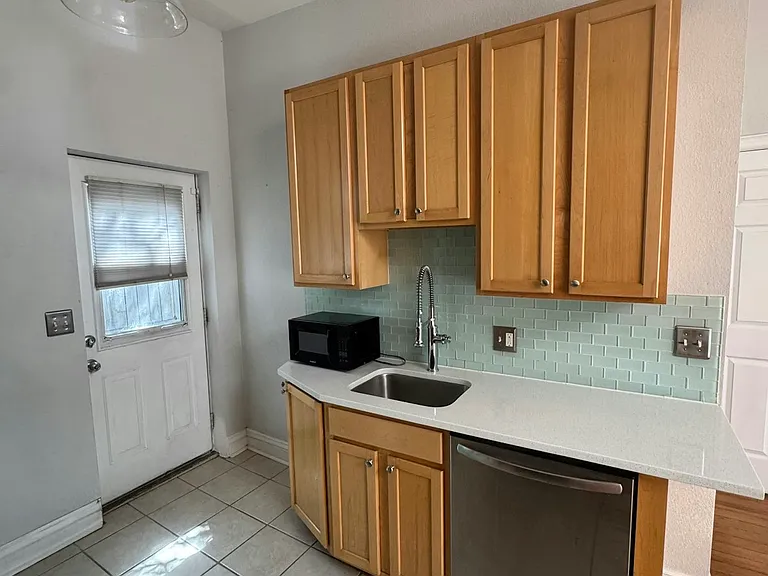 Kitchen with door to ack area