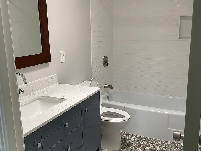 Remodeled bathroom with bathtub and skylight