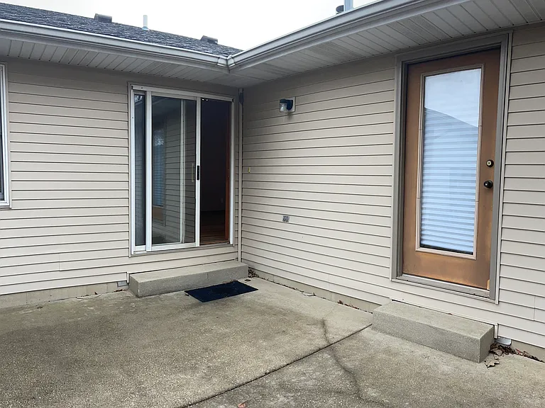 Private patio off the back of duplex with 2 entrances.