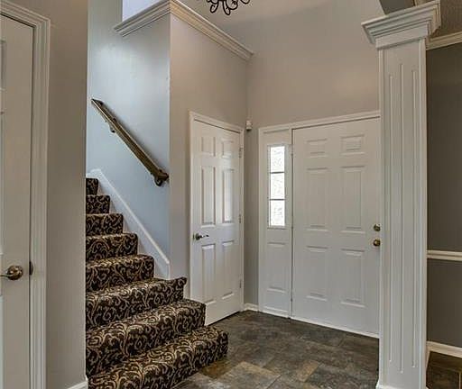 Soaring 2 Story Foyer!  Designer Carpet on Stairs & Iron Spindles!