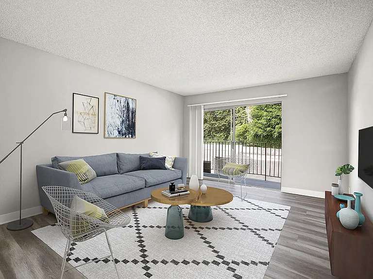 Hardwood floored living room with view of private patio.
