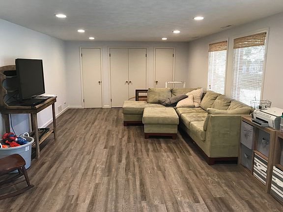 family with walkout to covered patio and beautiful backyard