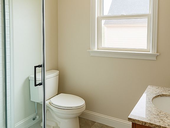 Bathroom with Glass Shower/Rain Showerhead and Granite Bathroom Vanity with matching Mirror/Storage.