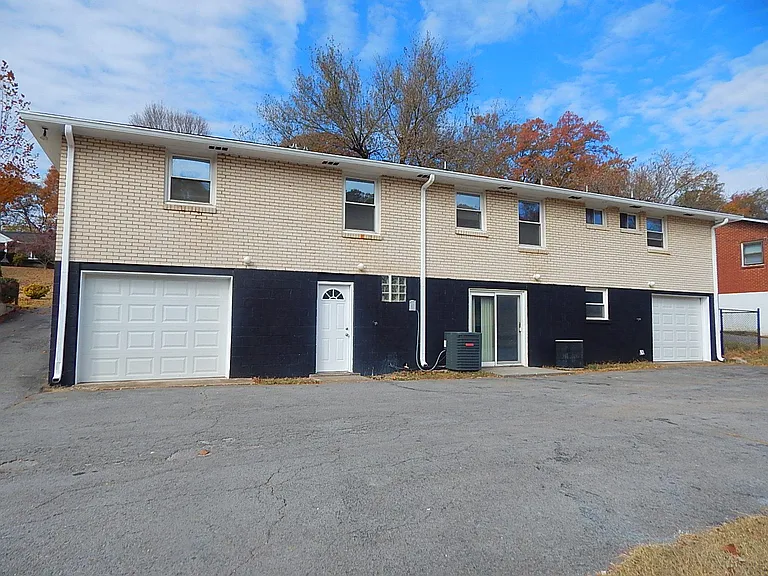 Back parking area and garage/sliding door entry (on right side of duplex).