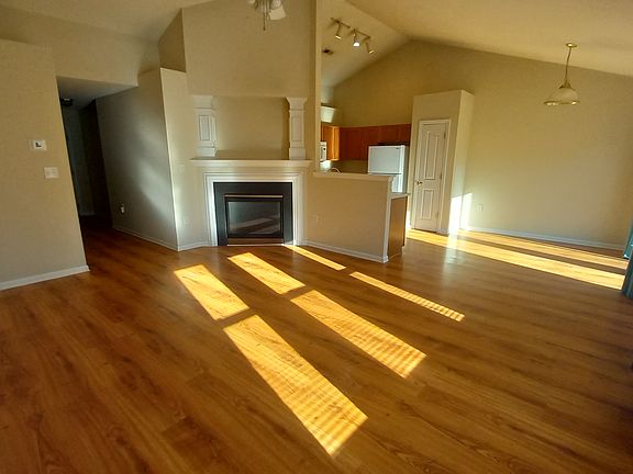 Gas fireplace in corner of great room open to dining and kitchen.