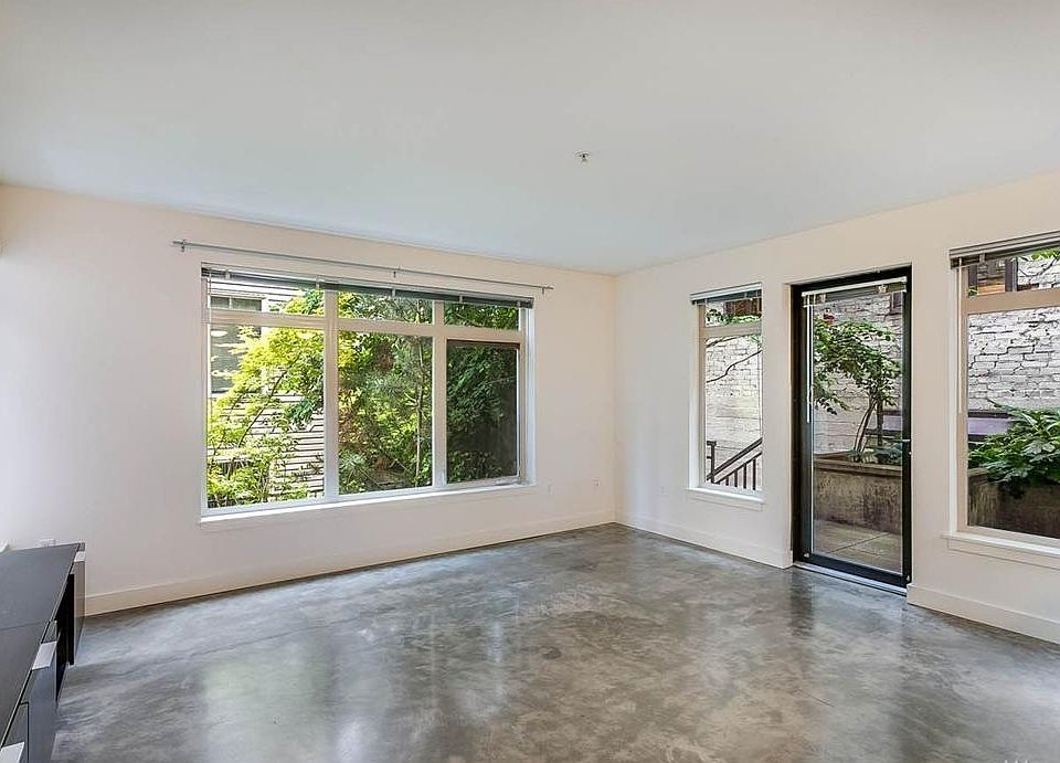 Living room with tons of windows and greenery