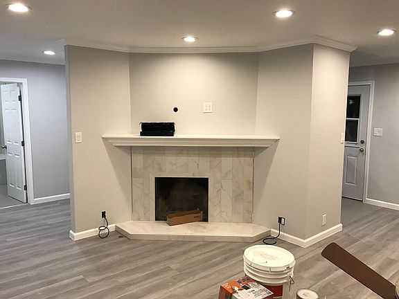 Fireplace in Living Room. To the right is the dining area. To the left is the hallway.