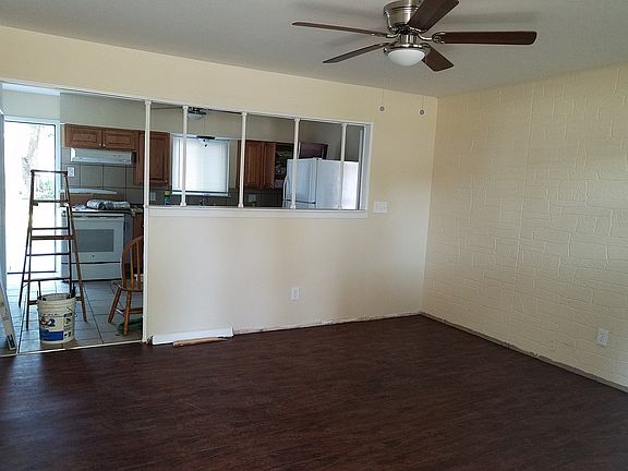 Living room area looking into kitchen.