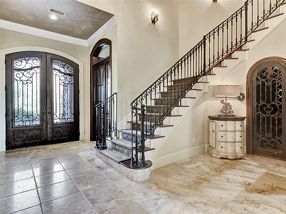 Wine Grotto with an abundance of wine storage elegantly placed behind a wrought iron door to keep your wine in optimal condition.
