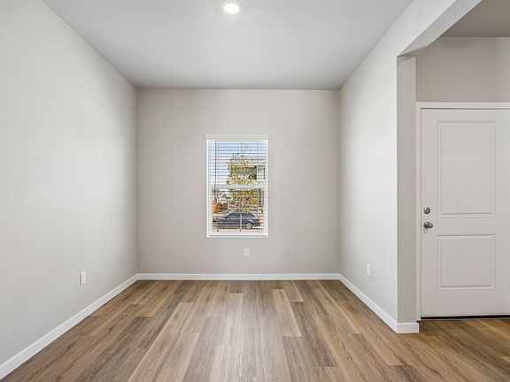 There is a dining room in the front of the house off the kitchen