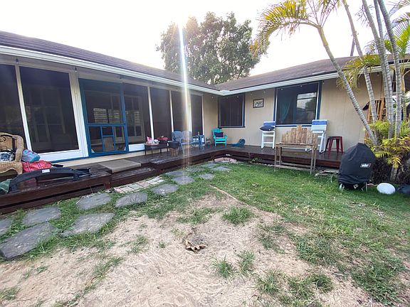 Front yard with big lanai and screened-in large porch. Master Bedroom on right side of picture.