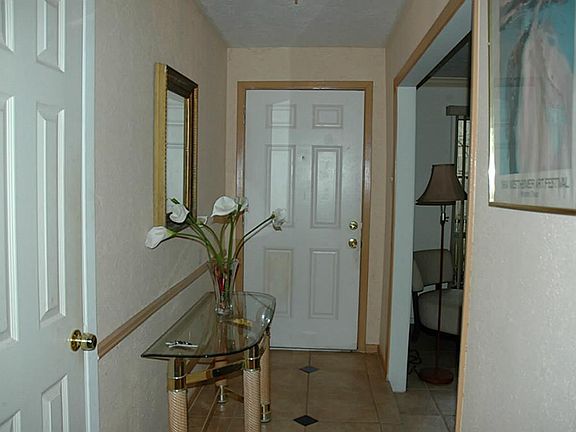 Front, tiled entry leading to the formal living area and dining room.