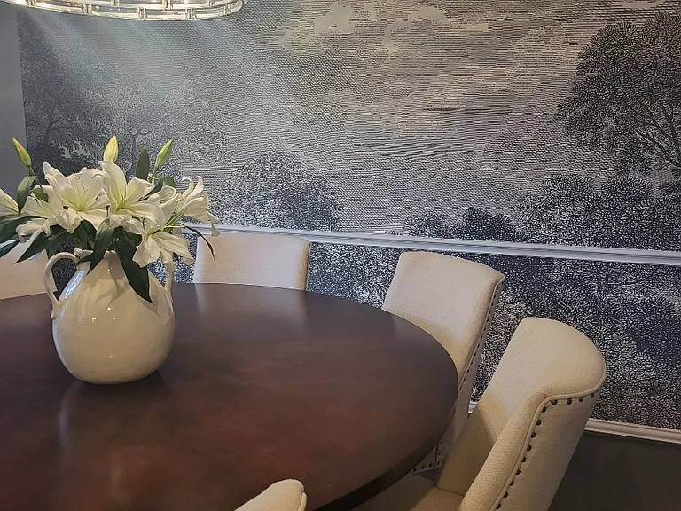 Designer dining room supported by premium chandelier and trendy wall mural