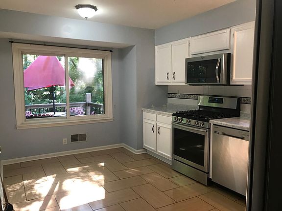 Kitchen with updated cabinets, countertops, and gas stove